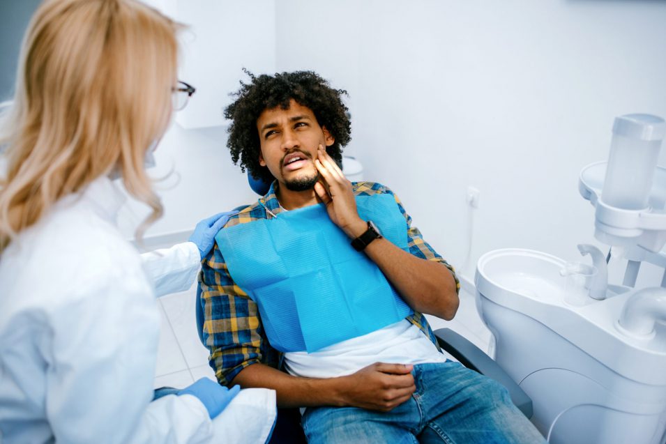 Man requiring emergency dentist for toothache